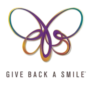Give Back a Smile logo representing a charitable dental program that restores smiles for survivors of domestic violence